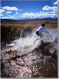 mountain biking across a creek