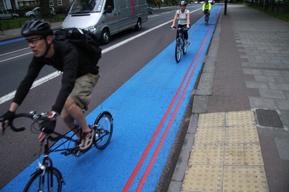 Three cyclists on a blue cycle superhighway