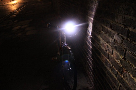 Blackburn flea light pointing towards brick wall at night