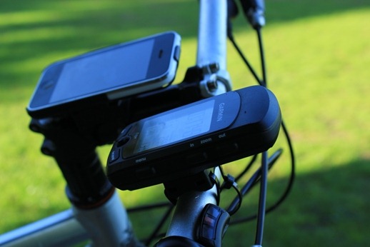 Garmin gps next to the iPhone on bicycle handlebars