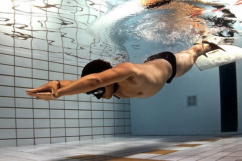 Freediver underwater diving with monofin during freediving competition in London UK