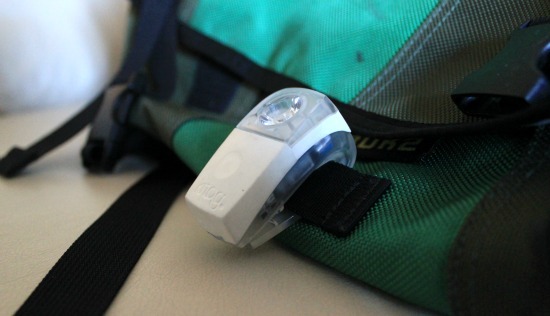 The Knog boomer bike light attached to a green messenger bag