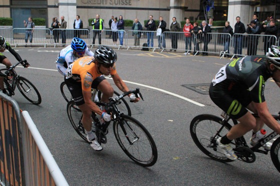 Professional cyclists going at speed around the track