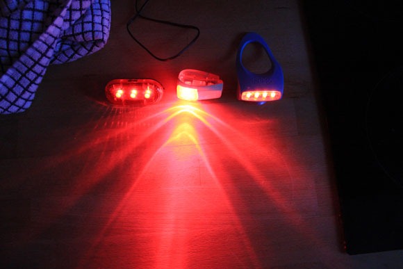The Knog wearable boomer, which is the light in the middle, is compared side by side to other lights proving it is brighter