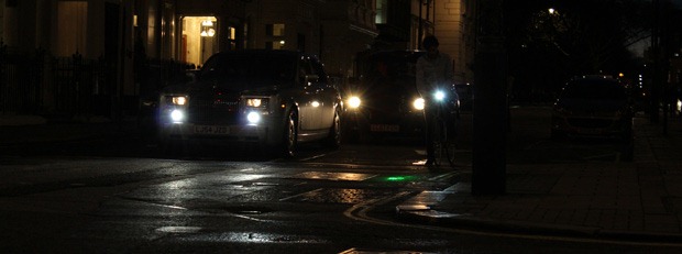 Faint bike light next to cars