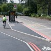 Cyclist riding around a bus stop in TRL testing facility